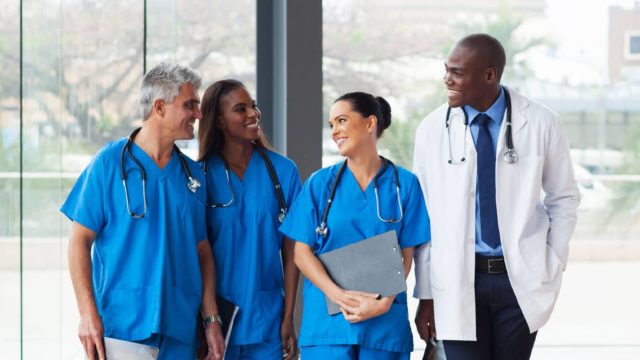 Group of healthcare providers walking in hospital