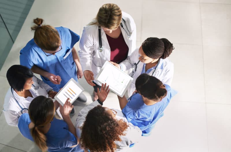 Medical practitioners analyzing data in a hospital