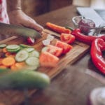 Man prepares vegetables in kitchen